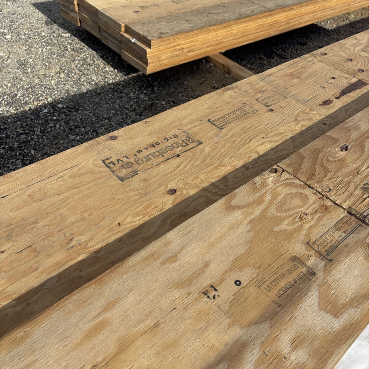 APA stamp visible on 1-3/4 inch by 16 inch laminated veneer lumber (LVL) beam stocked at Boise lumberyard