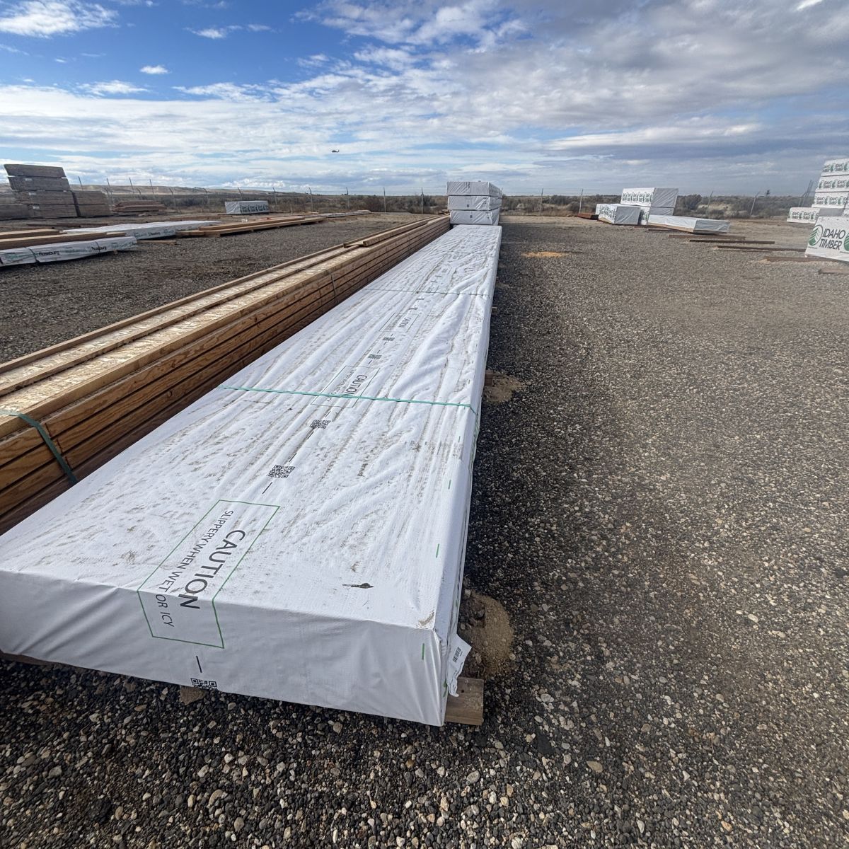 Roseburg RFPI-20 11-7/8 inch engineered wood I-joists stacked at Boise lumberyard with yard surface visible