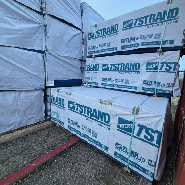 Angled view of 19/32 inch 4x8 OSB sheathing stacked at Boise lumberyard with other lumber SKUs visible