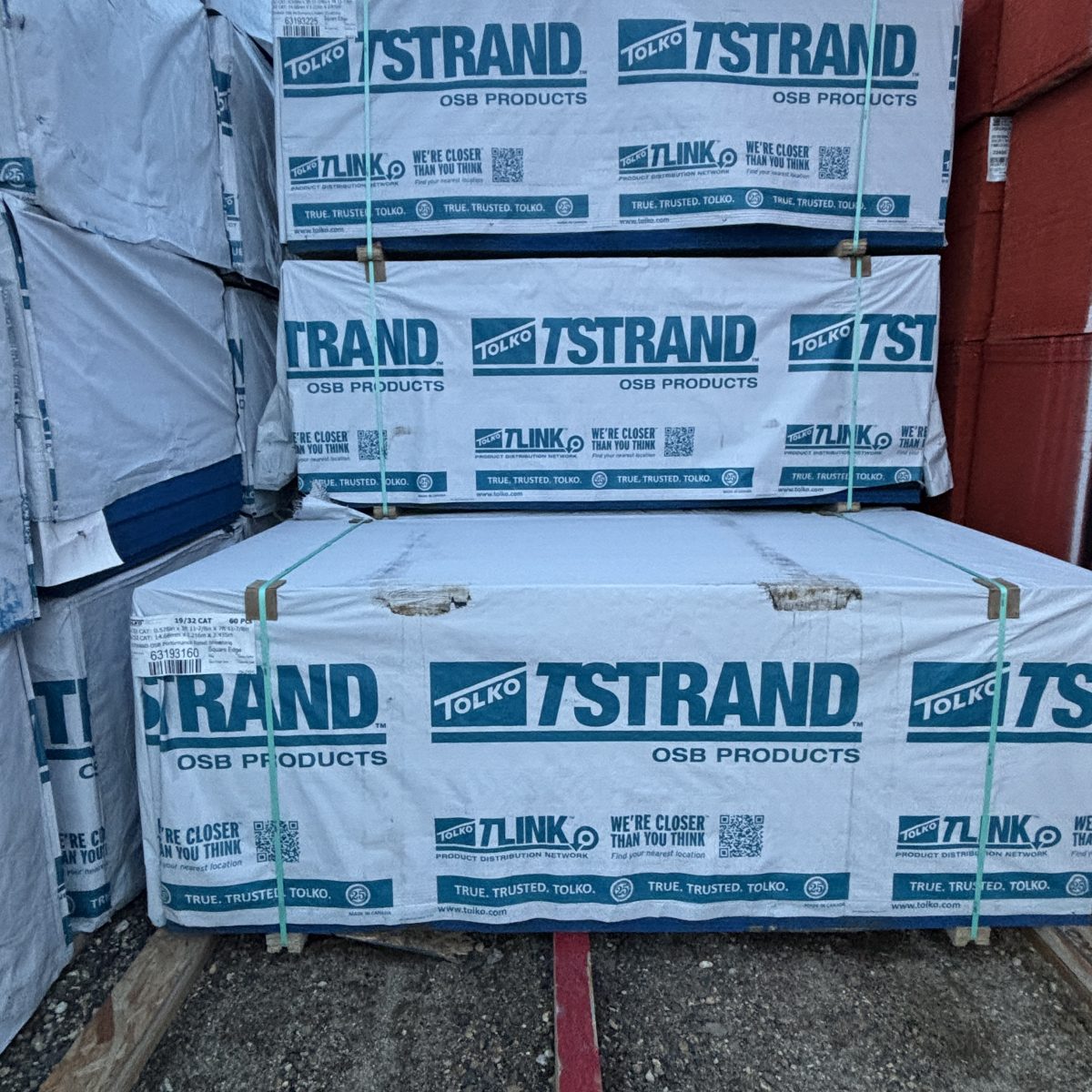 Stacked and wrapped 19/32 inch 4x8 OSB sheathing units shown as inventory at Boise lumberyard