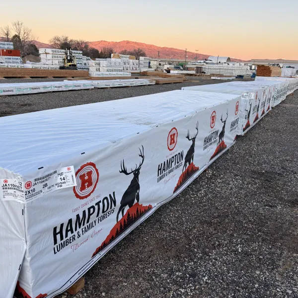 Angled view of multiple units of 2x10x14 foot number 2 grade kiln-dried Hem-Fir lumber stacked at Boise lumberyard