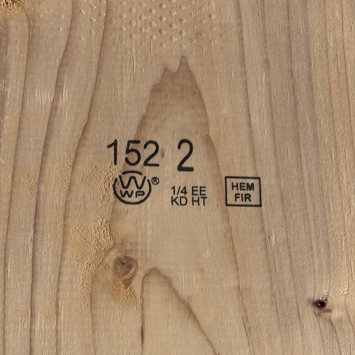 Grade stamp on 2×10 #2 kiln-dried Hem-Fir lumber showing grade and mill identification
