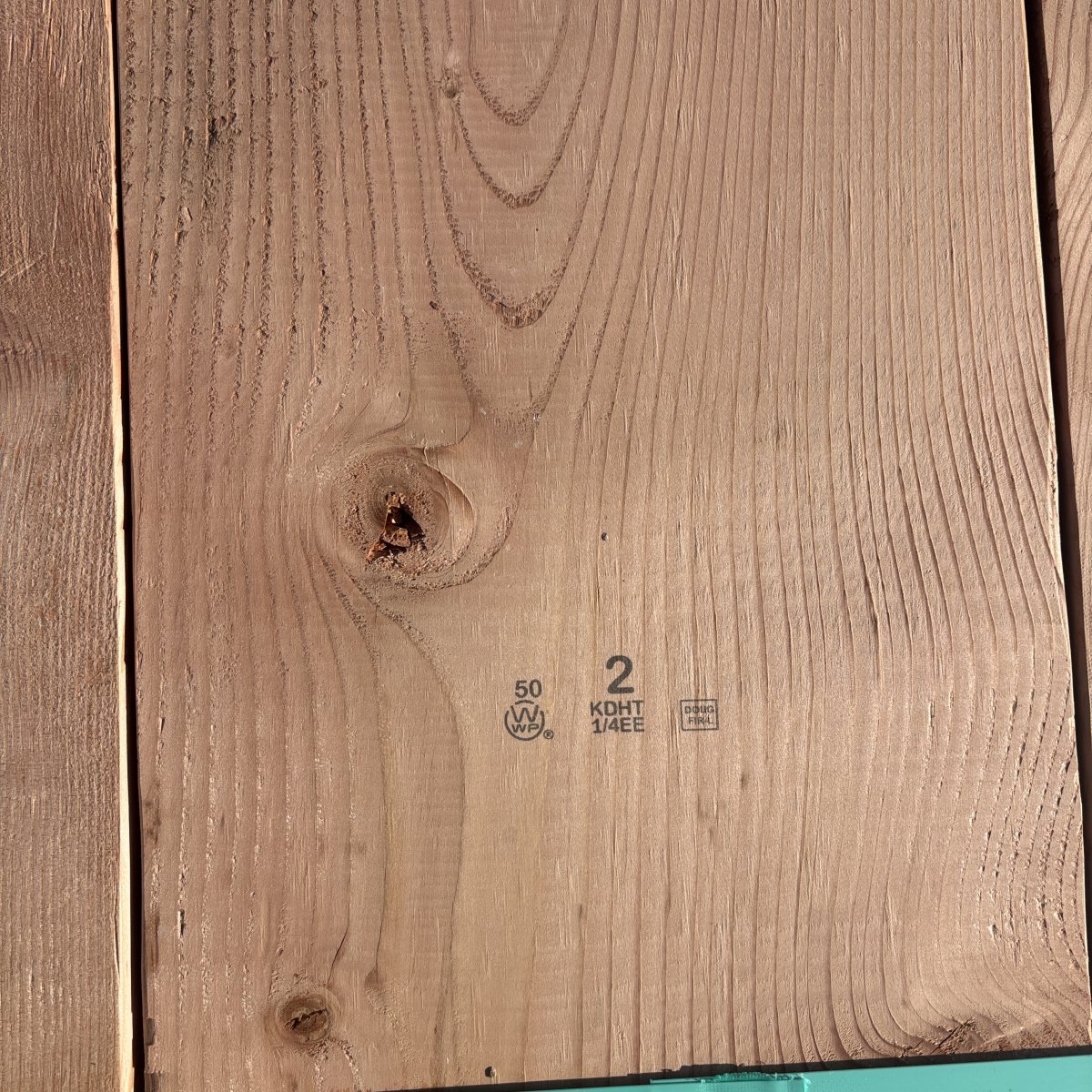 Grade stamp on 2×12 #2 kiln-dried Douglas Fir lumber showing grade and mill identification