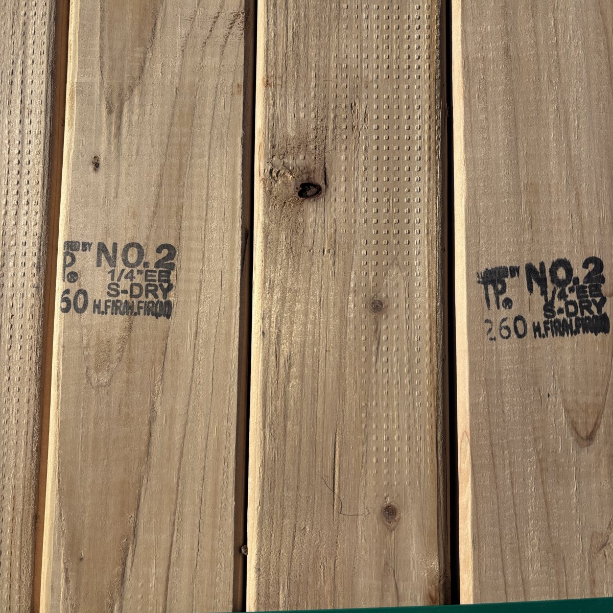 Grade stamp on 2×4 #2 kiln-dried Hem-Fir lumber showing grade and mill identification