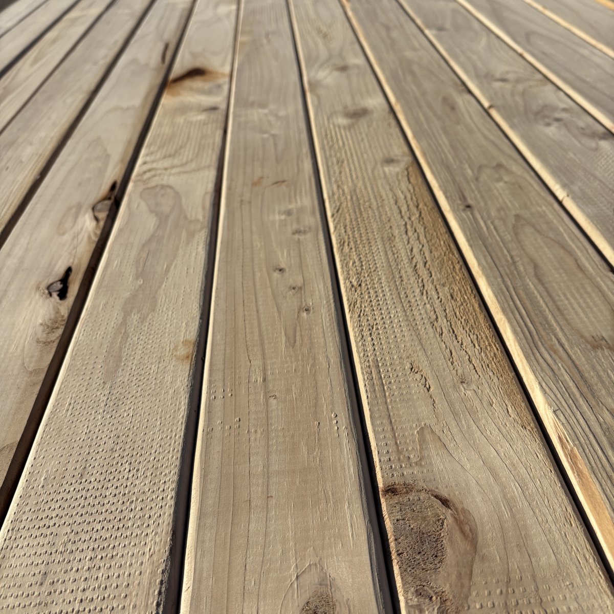 Close-up angled view of Hem-Fir wood grain on 2×4 #2 kiln-dried lumber showing natural texture and grain pattern