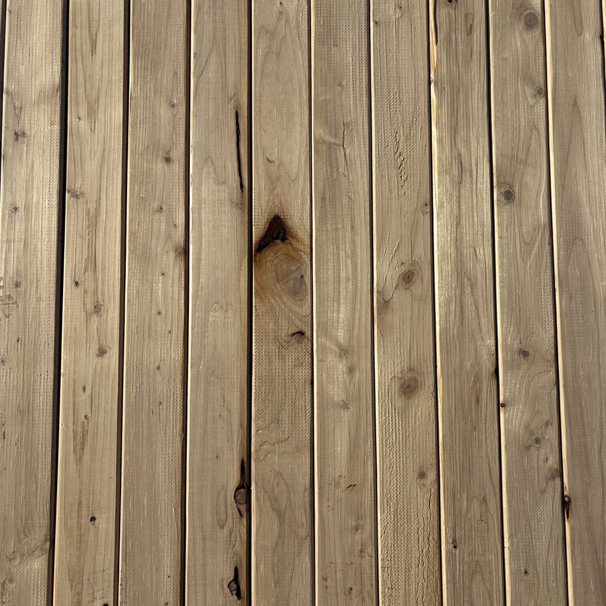 Top-down view of Hem-Fir wood texture on 2×4 #2 kiln-dried lumber showing grain pattern and surface detail