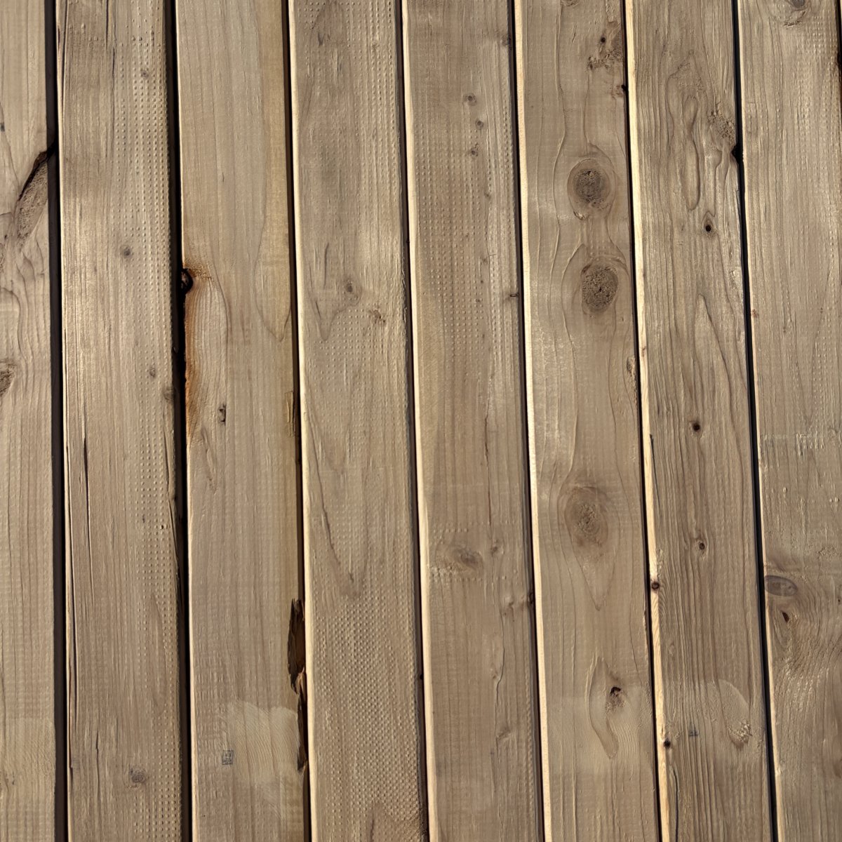 Top-down view of Hem-Fir wood texture on 2×4 #2 kiln-dried lumber showing grain pattern and surface detail