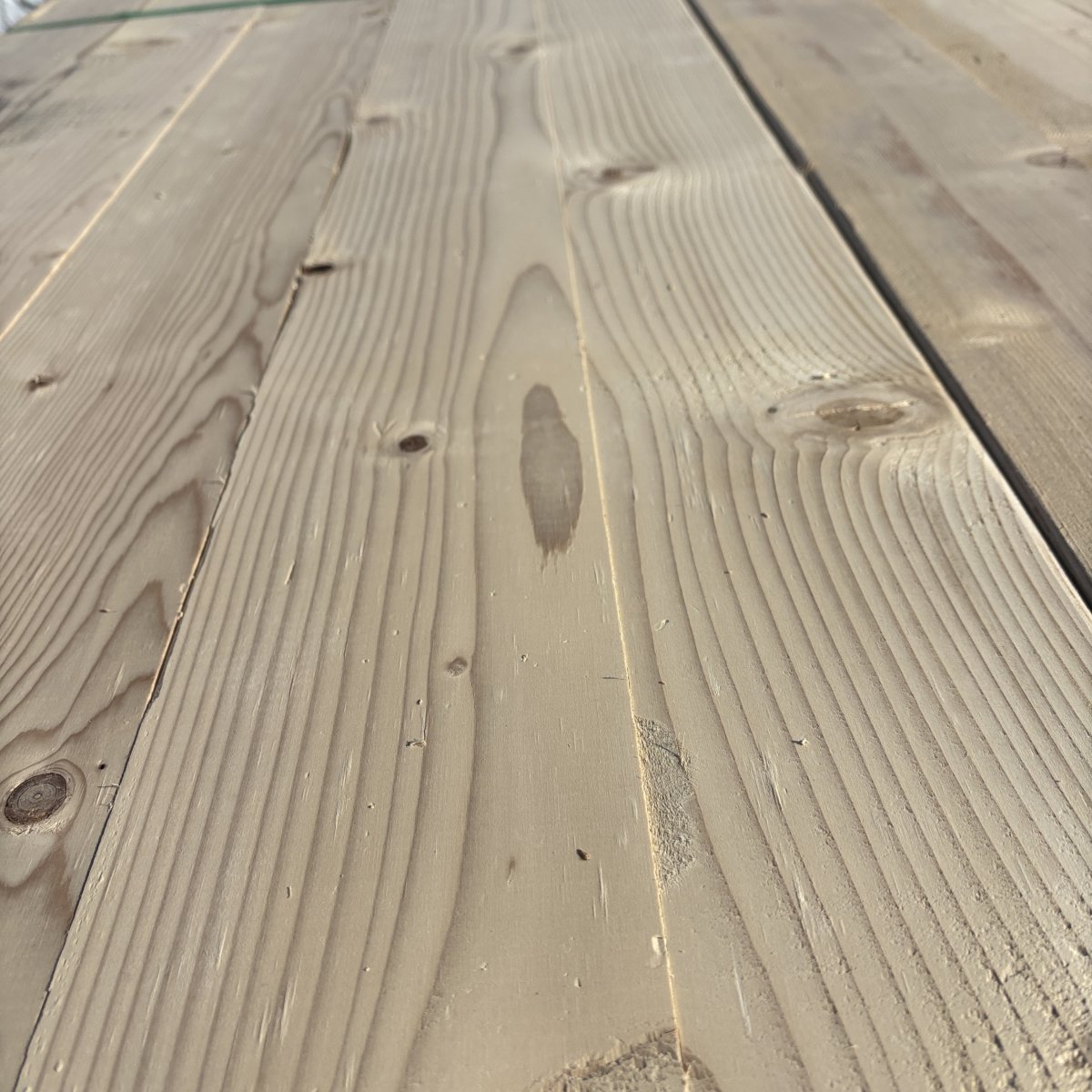 Close-up angled view of Hem-Fir wood grain on 2×6 #2 kiln-dried lumber showing natural texture and grain pattern