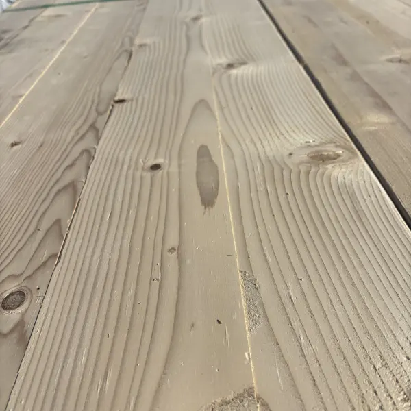 Close-up angled view of Hem-Fir wood grain on 2×6 #2 kiln-dried lumber showing natural texture and grain pattern