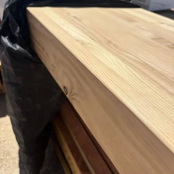 Close-up of a Douglas Fir 24F-V8 glulam beam at a Stockton, California lumber distribution center.