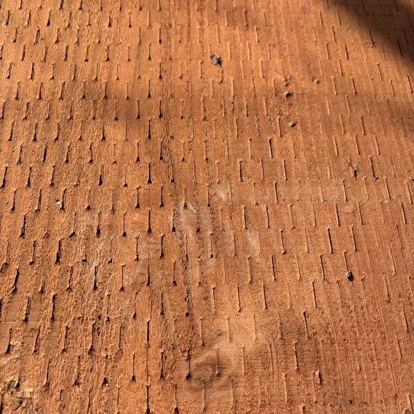 Close-up of incised surface on 4x ground contact pressure-treated #2 fir lumber (CAC treated)
